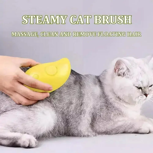 Person using yellow steamy cat brush to groom and massage a gray and white cat
